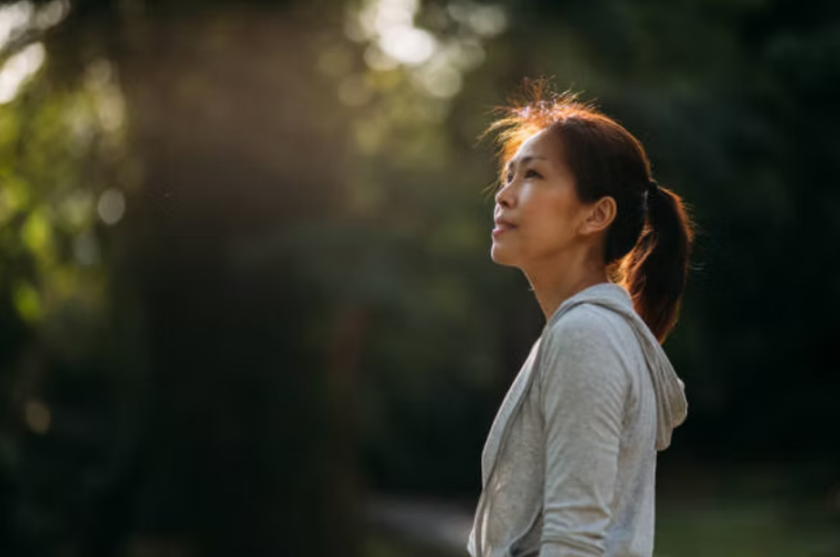Person gazing, smiling while reflecting on life purpose and personal growth
