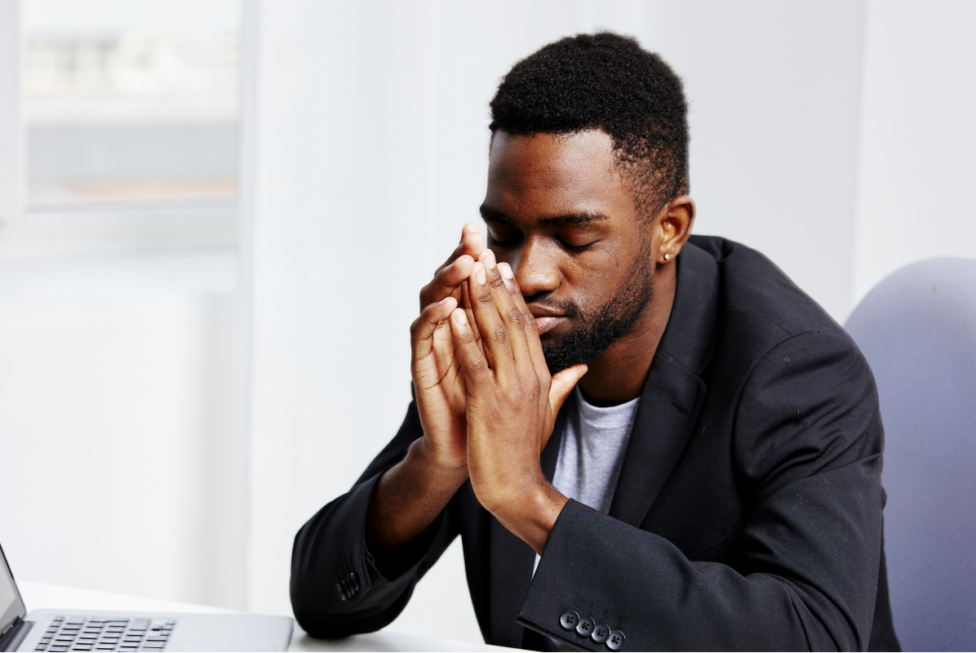Person feeling overwhelmed while working, illustrating how anxiety affects motivation, focus, and daily routines.