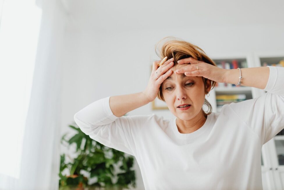 Individual experiencing stress, representing the emotional and physical effects of chronic stress.