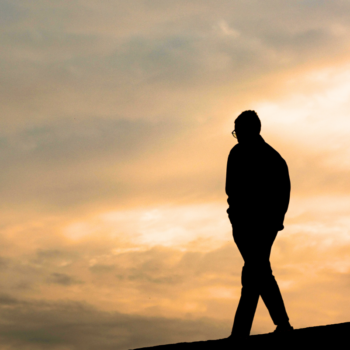 Person walking forward during sunset symbolizing faith and emotional growth during life transitions