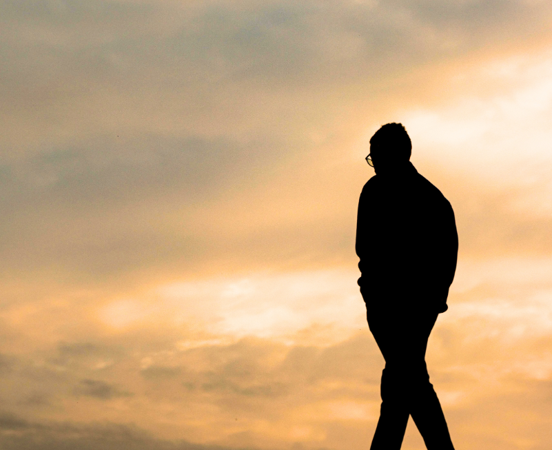 Person walking forward during sunset symbolizing faith and emotional growth during life transitions