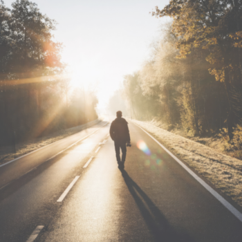 Person reflecting outdoors while coping with grief during a major life transition.
