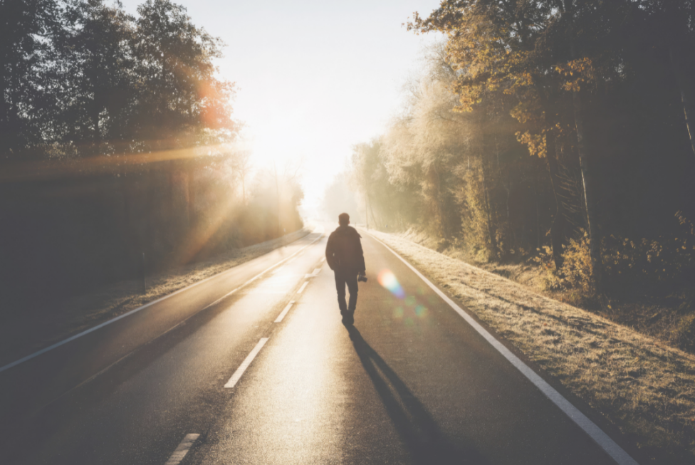 Person reflecting outdoors while coping with grief during a major life transition.