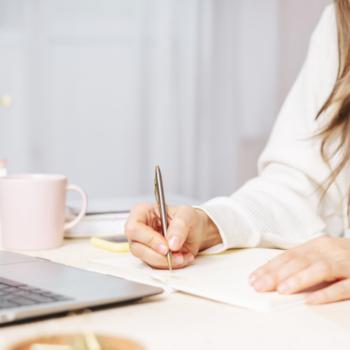 Person journaling and reflecting on personal goals and purposeful living.