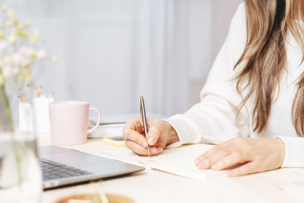 Person journaling and reflecting on personal goals and purposeful living.