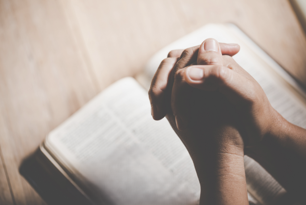 Person reading Scripture and reflecting on emotional resilience and mental health.